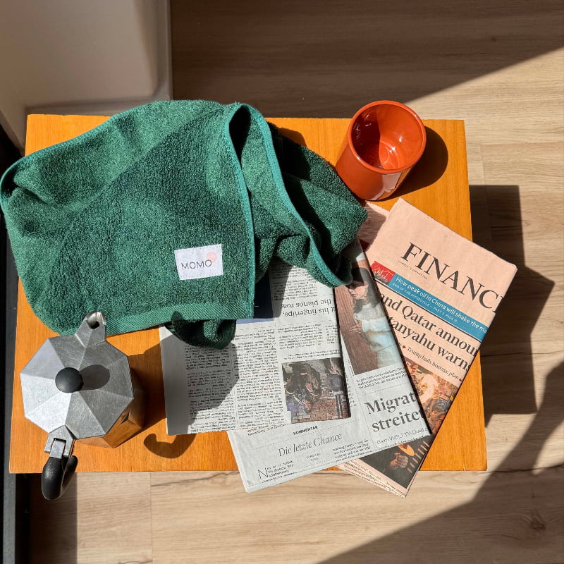 Close-up of green bamboo hand towel on table – soft, absorbent and sustainable