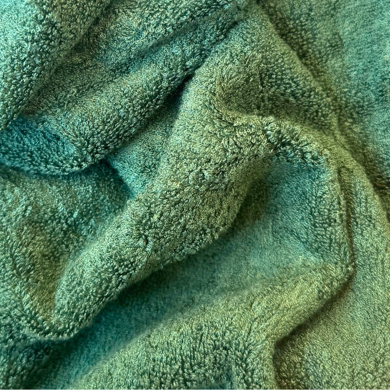 Close-up of green bamboo towel texture – soft, absorbent and sustainable