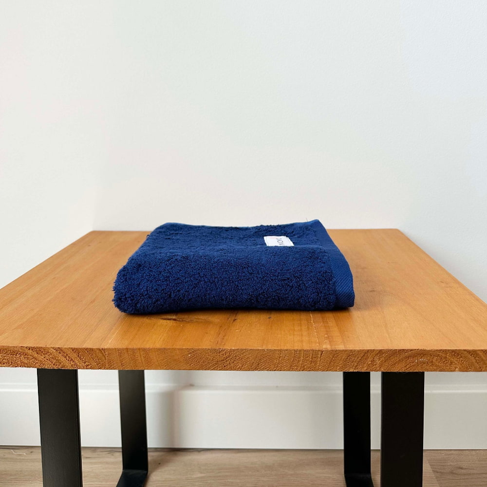 Blue bamboo hand towel on table – soft, absorbent and sustainable