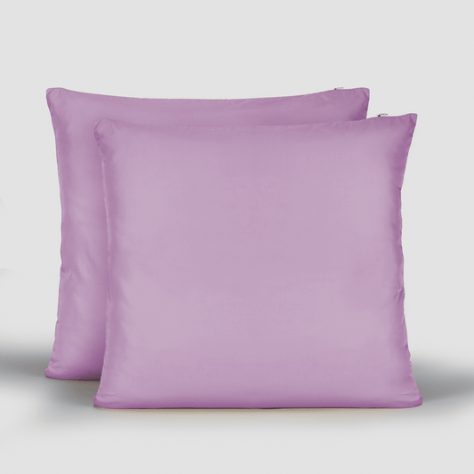 Pair of purple bamboo cotton pillowcases displayed in front and side view on light grey background.