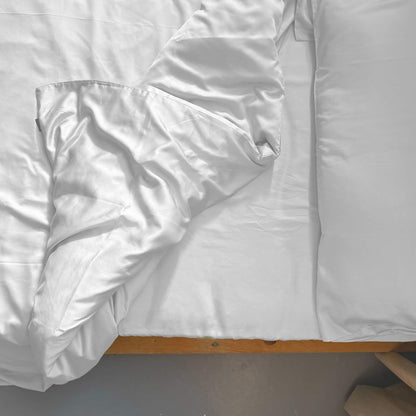 Top view of white bamboo duvet set with pillows – soft, breathable and sustainable bedding